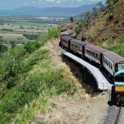a train traveling down a dirt road