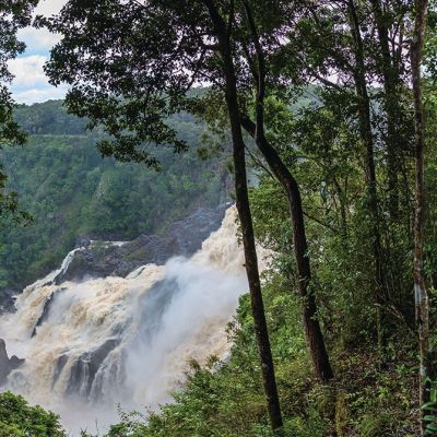 a person standing next to a waterfall