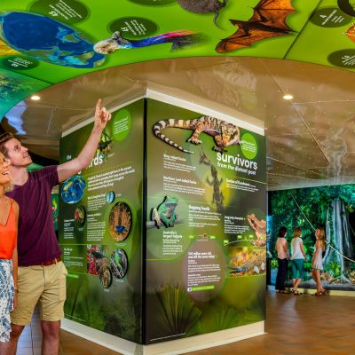 a young girl standing in front of a store